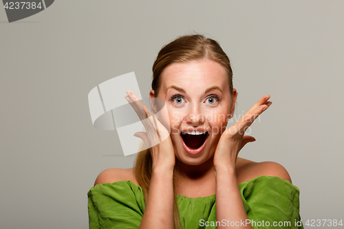 Image of Surprised woman in green sweater