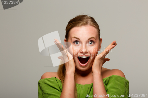 Image of Surprised woman in green sweater