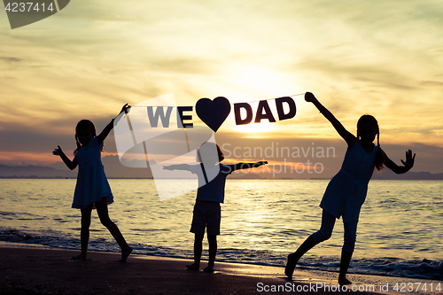 Image of Happy children playing on the beach