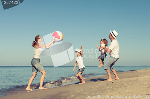 Image of Happy family playing on the beach at the day time.