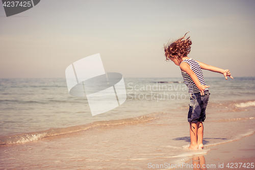 Image of  Portrait of little boy standing on the beach