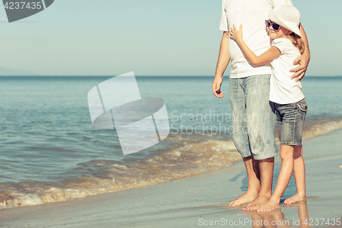 Image of Father and daughter playing on the beach.