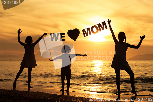 Image of Happy children playing on the beach