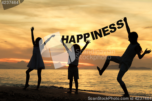 Image of Happy children playing on the beach