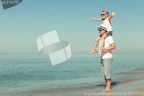 Image of Father and daughter playing on the beach.