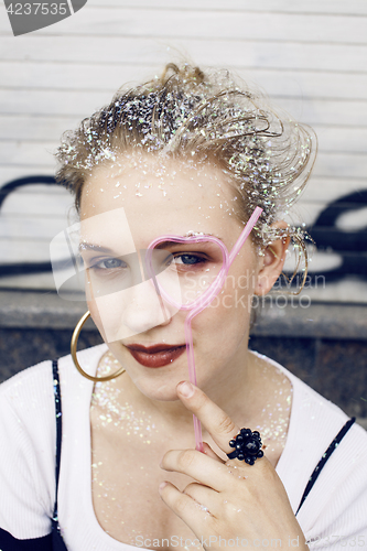 Image of young pretty party girl smiling covered with glitter tinsel, fashion dress, stylish make up, lifestyle people concept close up