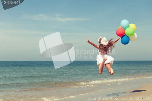 Image of Teen girl  jumping on the beach