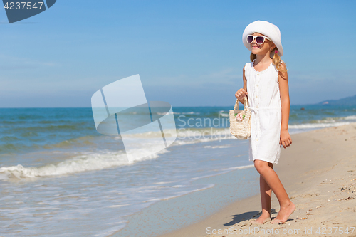 Image of Little girl  standing on the beach