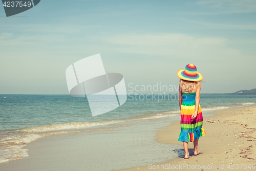 Image of Little girl  standing on the beach