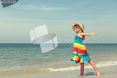 Image of Little girl  standing on the beach