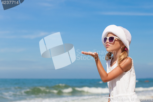 Image of Little girl  standing on the beach