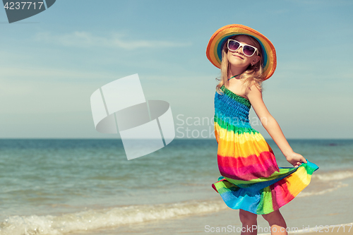 Image of Little girl  standing on the beach