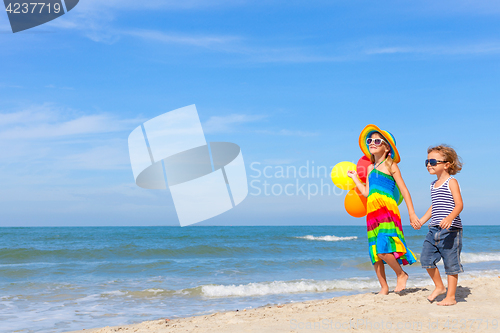 Image of happy children playing on the beach