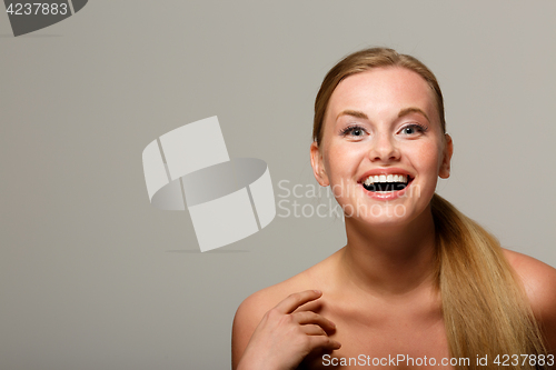 Image of Smiling woman on gray background