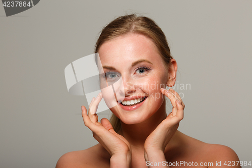 Image of Smiling woman on gray background