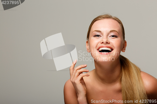 Image of Smiling model on gray background