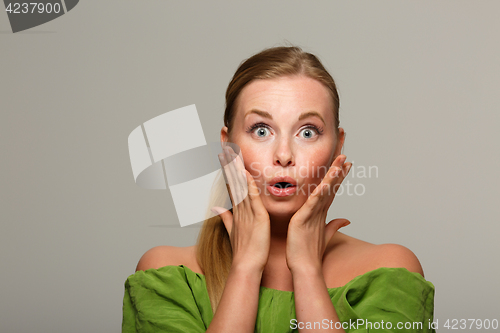 Image of Surprised girl in green sweater