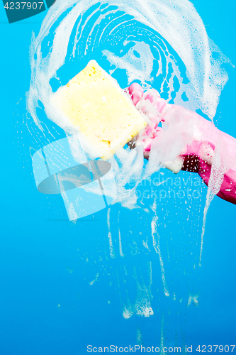 Image of Person with sponge washes window