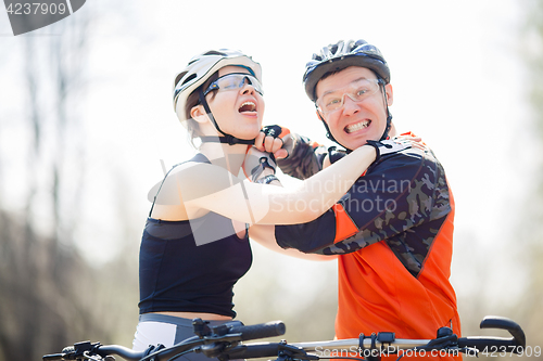 Image of Two cheerful bikers wear helmets