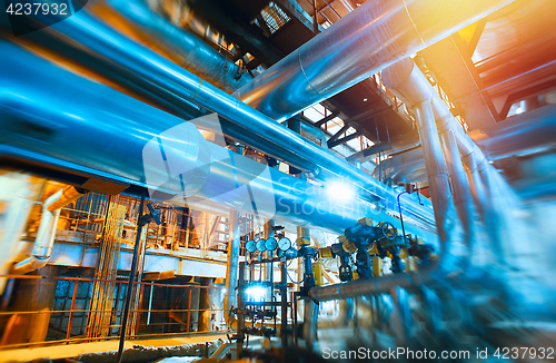 Image of Industrial Factory. Various mechanisms and metal pipes. Toned im