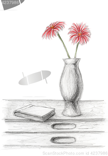 Image of Two red flowers in a vase on desk with book