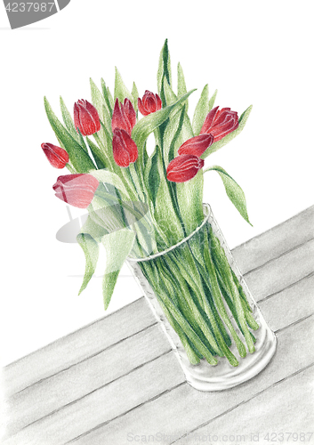 Image of Bunch of a tulips in a glass vase on a table