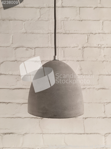 Image of Concrete lamp on white brick background