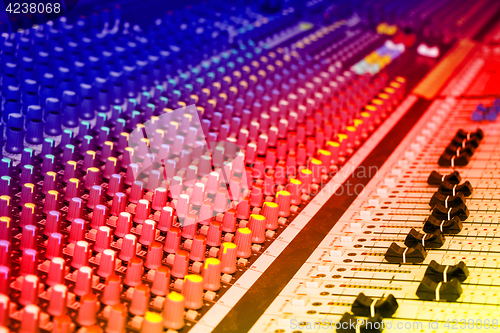 Image of Sound mixing console with colorful backlit buttons