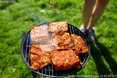 Image of meat cooking on barbecue grill at summer party