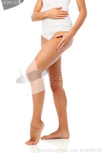 Image of legs of beautiful young woman in white underwear