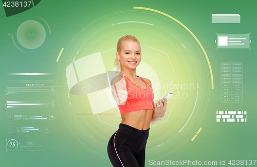 Image of smiling sporty woman with smartphone