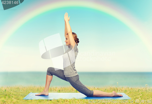 Image of happy woman making yoga in low lunge on mat