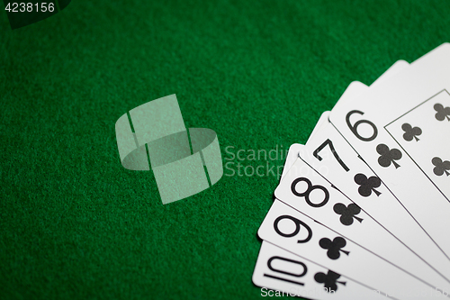 Image of poker hand of playing cards on green casino cloth