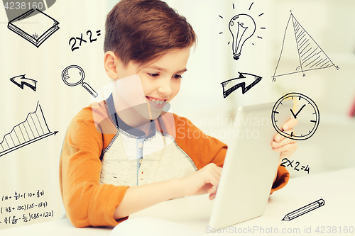 Image of smiling boy with tablet pc computer at home