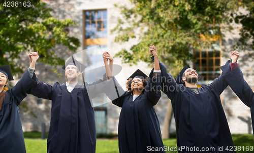 Image of happy students or bachelors celebrating graduation