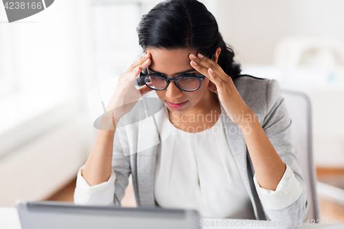 Image of stressed businesswoman with laptop at office