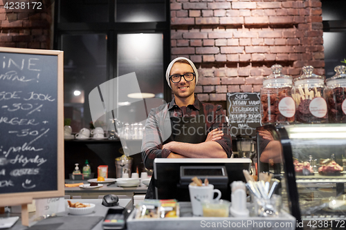 Image of happy seller man or barman at cafe counter