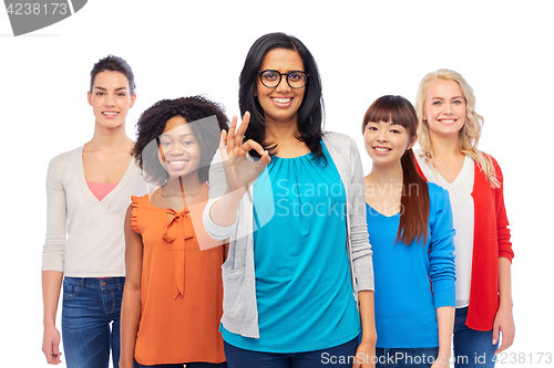 Image of international group of happy women showing ok