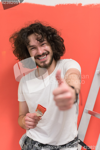 Image of man with funny hair over color background with brush