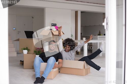 Image of African American couple  playing with packing material