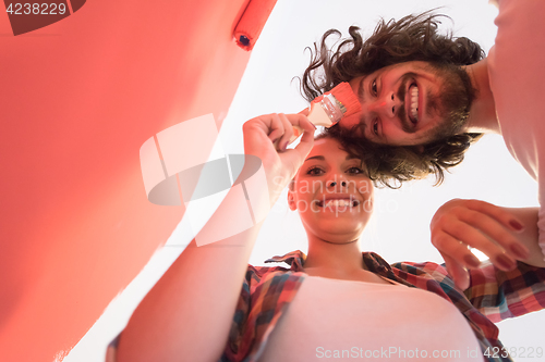 Image of couple painting interior wall