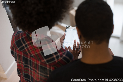 Image of african american couple using tablet at home