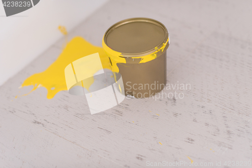 Image of Yellow paint tin can