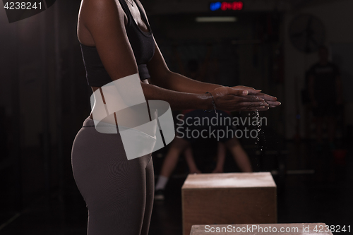 Image of black woman preparing for climbing workout