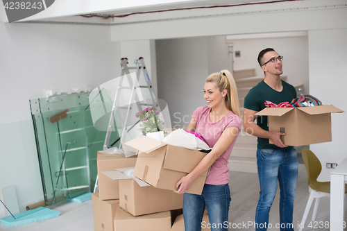 Image of young couple moving into a new home