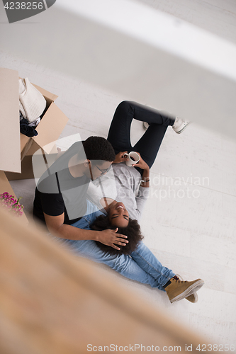 Image of African American couple relaxing in new house