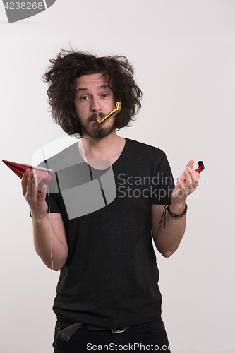 Image of Portrait of a man in party hat blowing in whistle