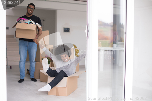 Image of African American couple  playing with packing material