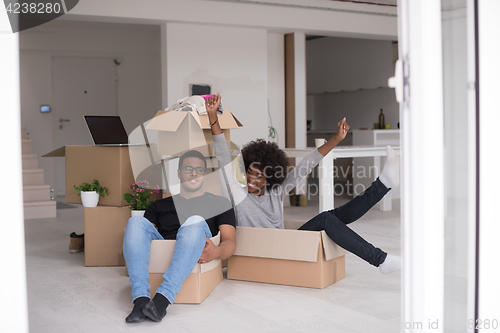 Image of African American couple  playing with packing material