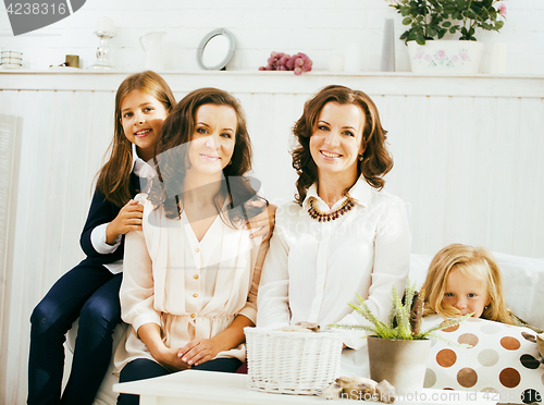 Image of Mature sisters twins at home with little daughter, happy family 